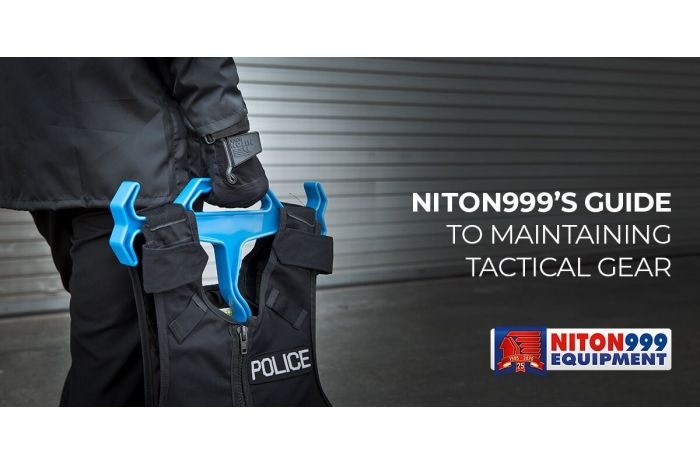 Police officer carrying vest on hanger