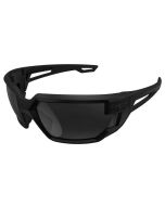 The image shows the Tactical Type-X Safety Glasses with Smoke Lens from a frontal angle. These glasses feature a robust, full-frame design with dual dark smoke lenses. The black frame is sleek and durable, providing a secure fit. The smoke lenses block pr